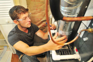 MCC HVAC student working on a furnace