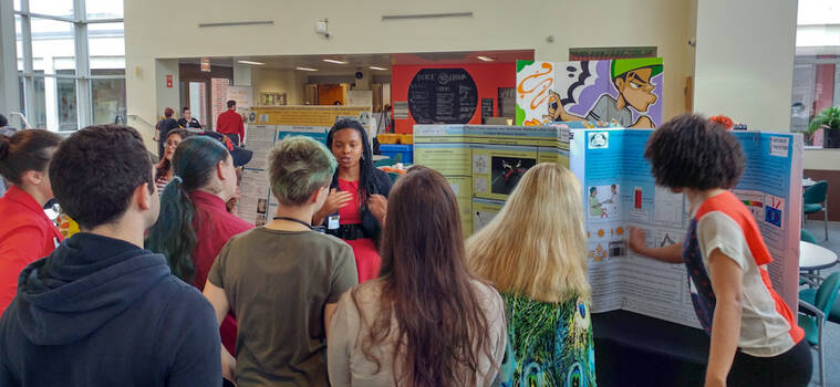 Presenter speaking to students about her research.