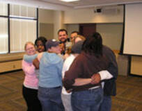 student employees engaging in a group hug