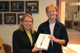 student winner #2 being handed an Ipad