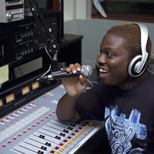 MCC student at console in WMCC, The Pulse, radio station