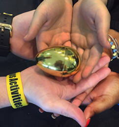 Student hands holding the lucky golden egg