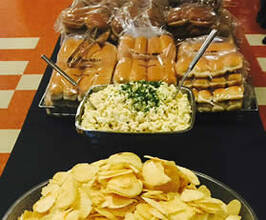 Chips, rolls and mac salad on a table