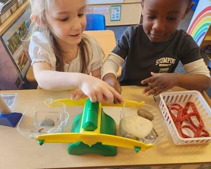 Children playing with a scale