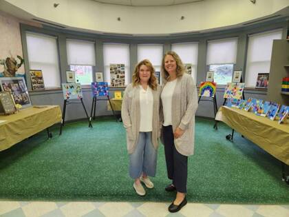 child care staff posing for a picture in front of display