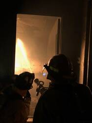 Firefighters entering burning building