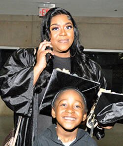 MCC graduate with her child at 2023 commencement