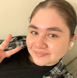 Portrait of MCC graduating student Haley Collado making a peace sign