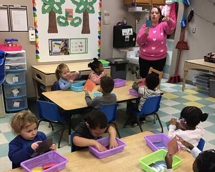 Children learning with paper shapes