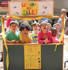 little kids running a lemonade stand