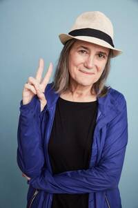 Amy Goodman poses with a peace sign.