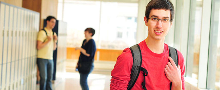 Photo of male student in a campus hallway