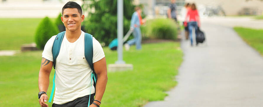 Photo of male student walking outside