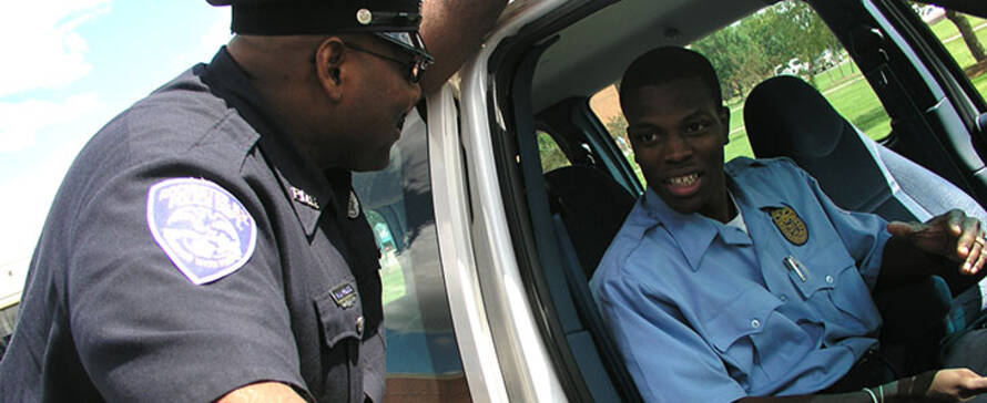 police officer talking to another officer in car