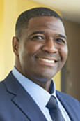 Head shot of Robin Cole smiling wearing a suit with tie.