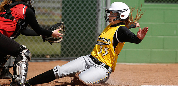 MCC Lady Tribune softball player sliding into home plate.