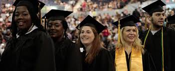 MCC graduates standing together