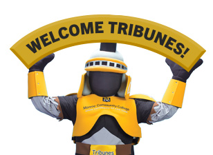 MCC Tribunes mascot holding a "Welcome Tribunes" sign